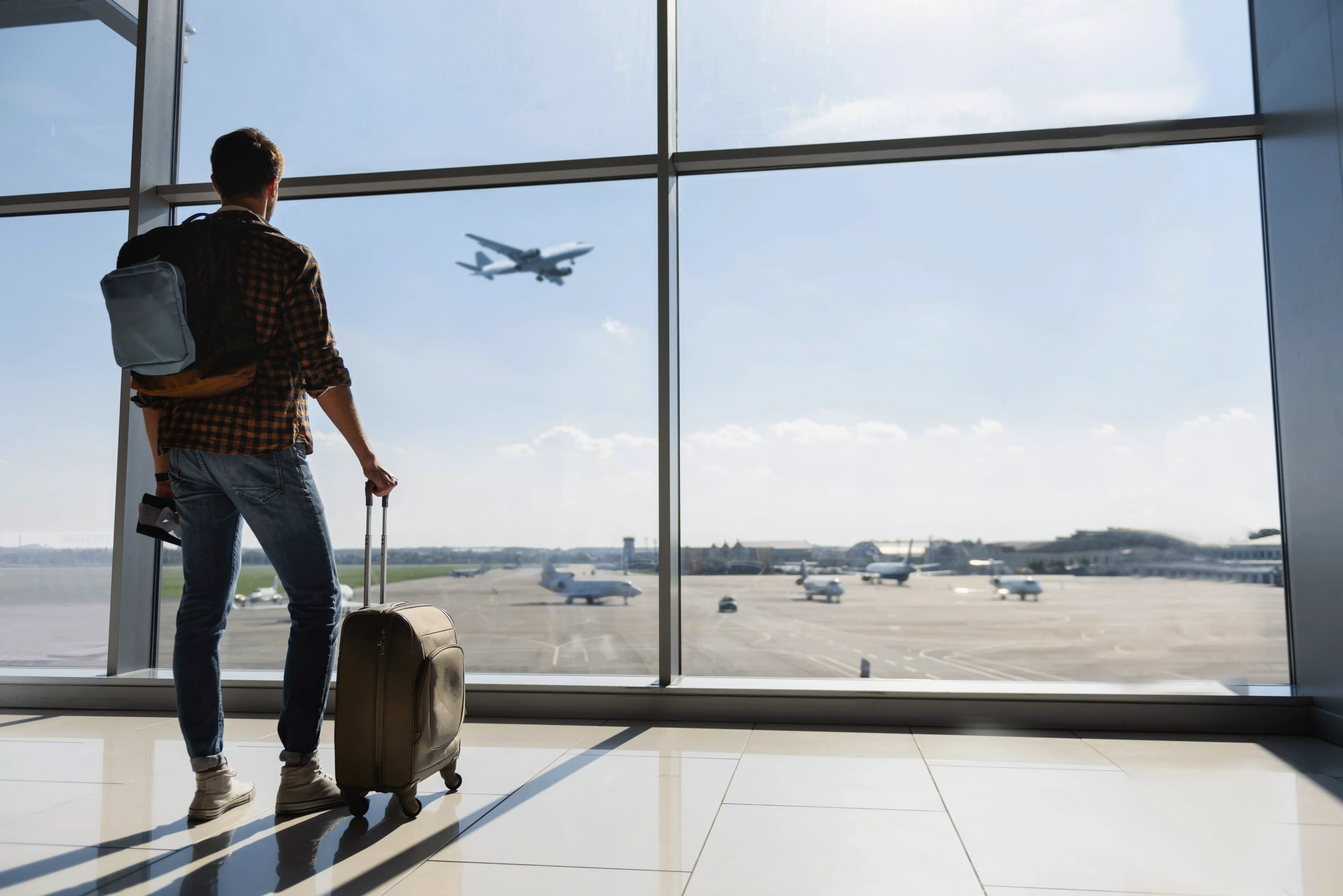 Traveller looking out from an airport